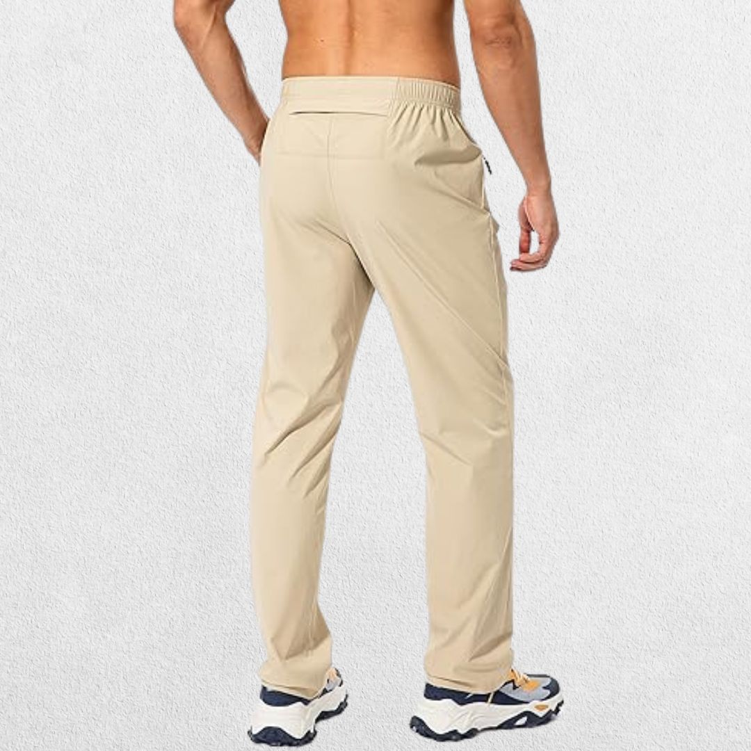 Men's khaki athletic trousers with a sleek design and functional back zipper pockets for storage during workouts.