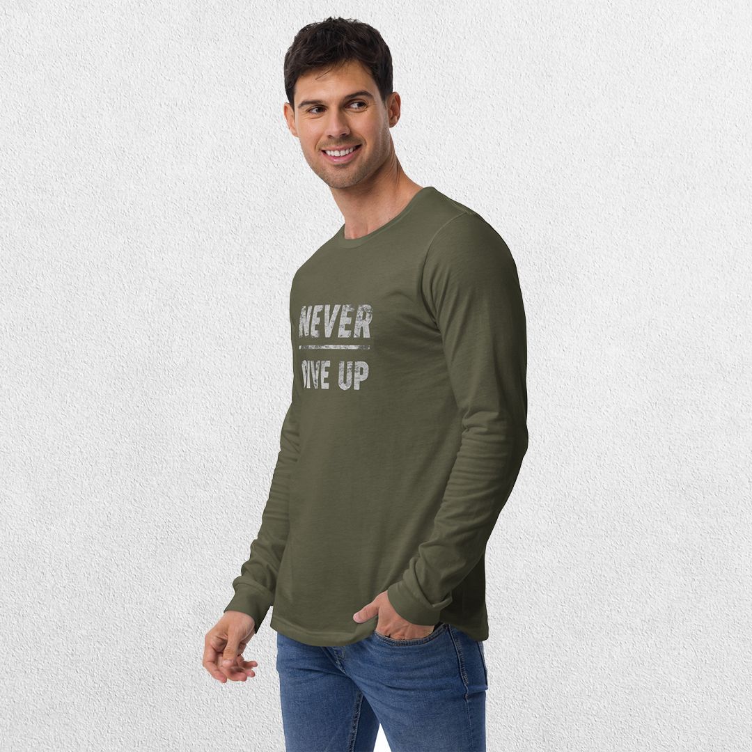 Model wearing the Military Green GPW Never Give Up Performance Long Sleeve Tee with jeans in a studio background.