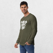 Model wearing the Military Green No Days Off Unisex Long Sleeve Tee - Versatile Athletic and Casual Wear with jeans in studio background.