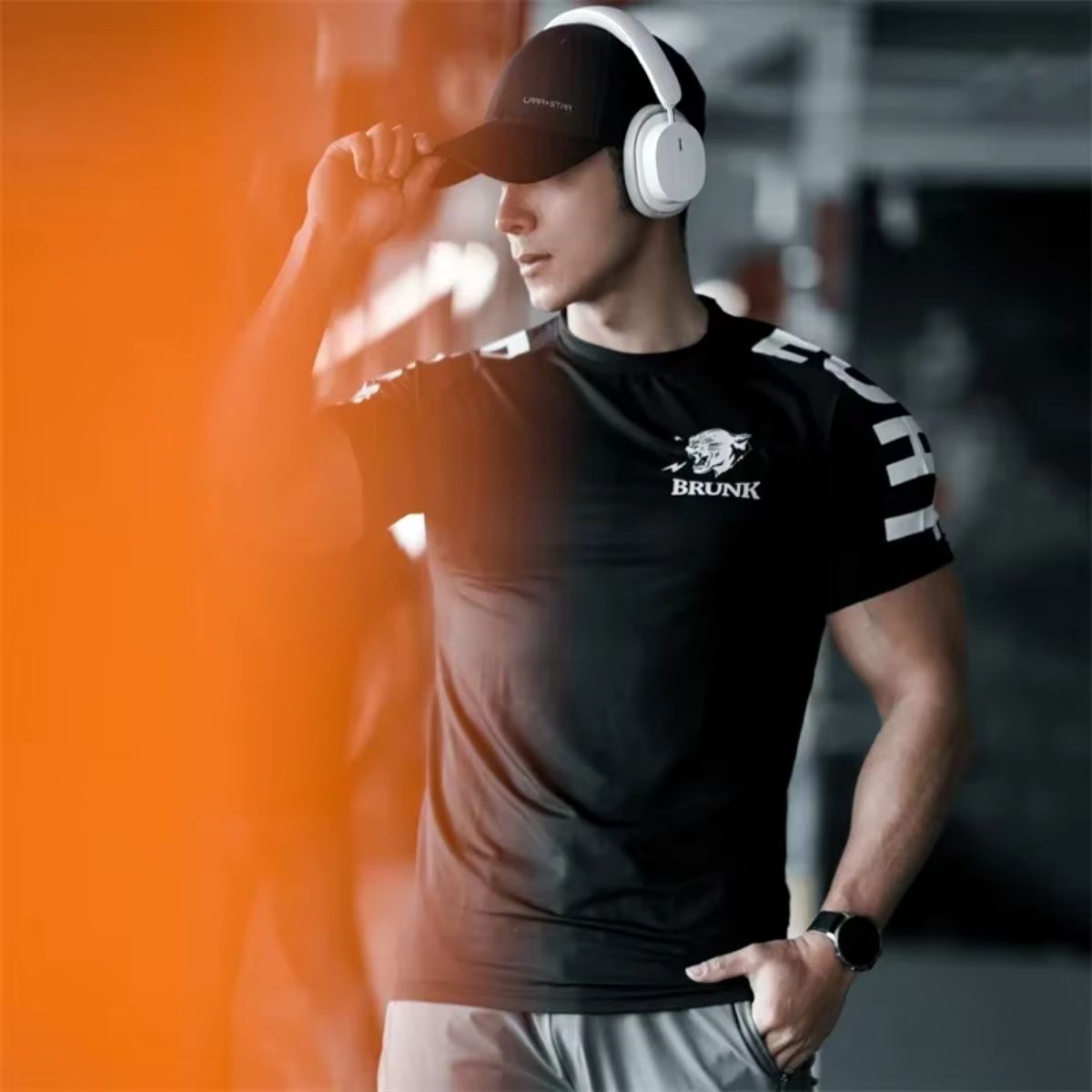 Model in gym wearing black GPW Men's Quick-Dry T-Shirt, ideal for workouts with breathable, flexible fabric.