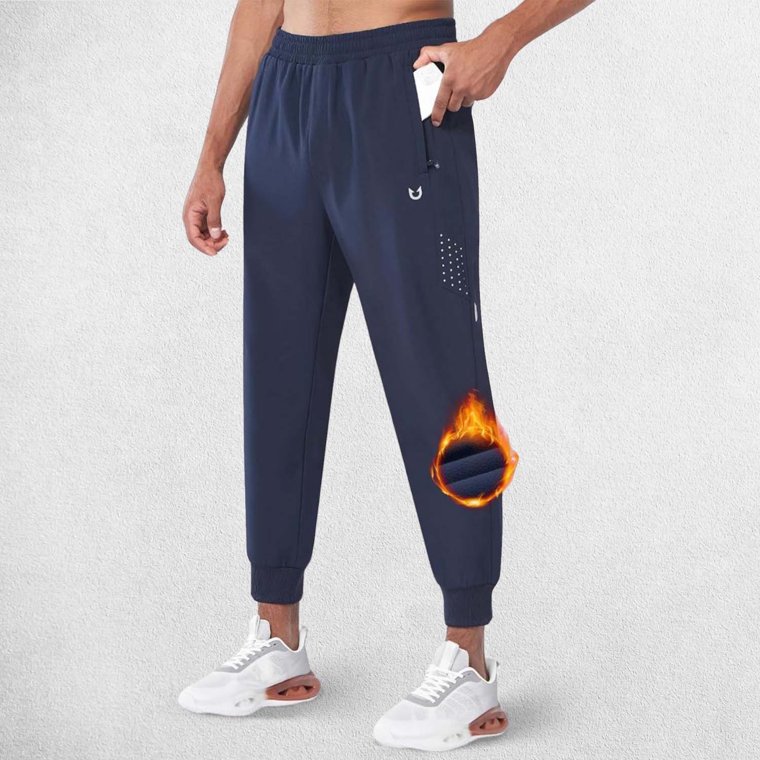 Side profile of ModelWearing Navy Fiece trouser showcasing the deep pockets and athletic fit of the trousers.