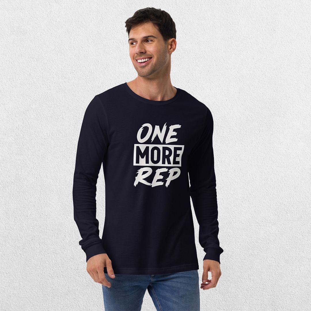 Model wearing the Navy GPW One More Rep Unisex Motivational Long Sleeve Tee with jeans in studio background.