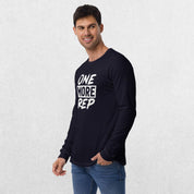 Model wearing the Navy GPW One More Rep Unisex Motivational Long Sleeve Tee with jeans in studio background.