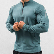 Close-up of Payne Gray Green GPW Men's Compression Shirt - Long Sleeve Rashguard for Fitness in a studio background