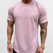 Close-up of Pink GPW Men's Fit Summer Gym T-Shirt - Bodybuilding Streetwear Tee in a studio background