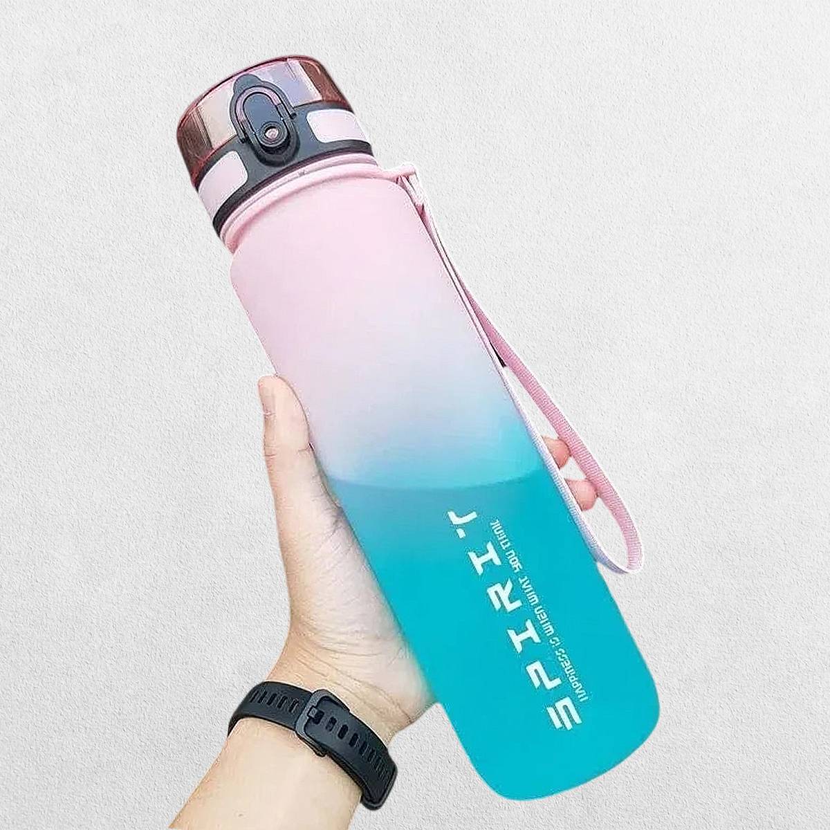 Person Holding Vibrant gradient water bottle with a flip-top lid and carrying strap.