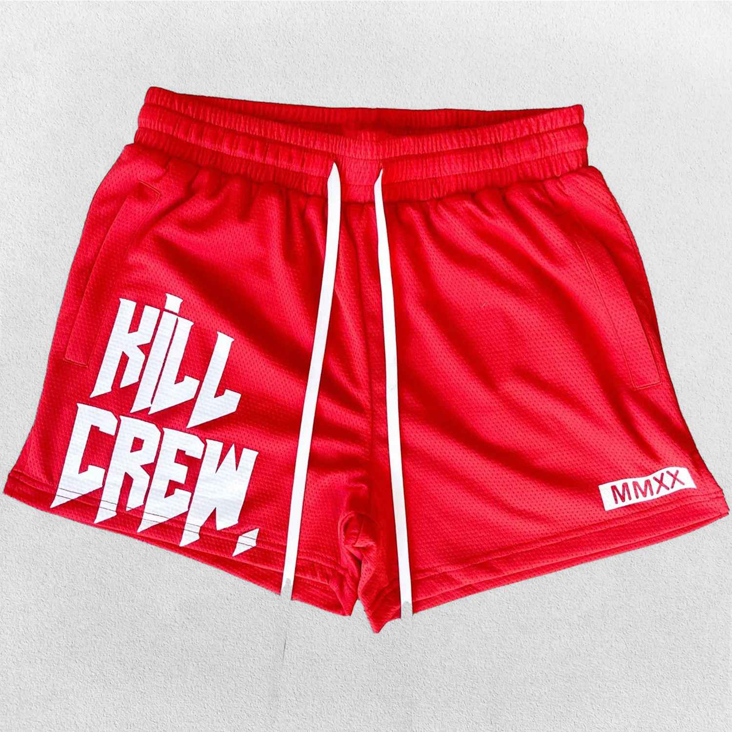 Close-up of Red GPW gym shorts with adjustable waist band in a studio background