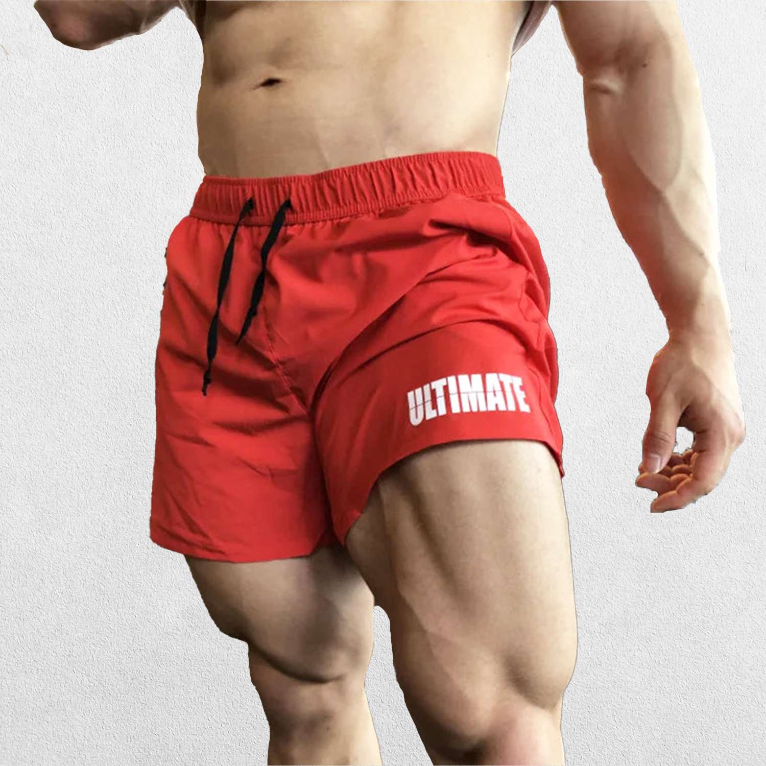 Model wearing Red GPW Men's Quick-Dry Fitness Shorts - Loose Beach Workout Bottoms