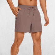 Front Close-up of Rosy Brown GPW Men's Lightweight Quick-Dry Workout Shorts with Pockets in a studio background