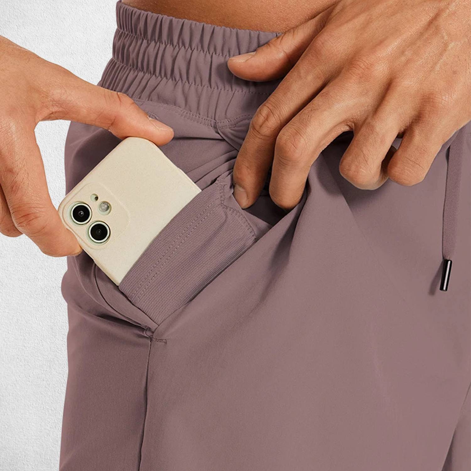 Close-up of Rosy Brown GPW Men's Lightweight Quick-Dry Workout Shorts with Pockets in a studio background