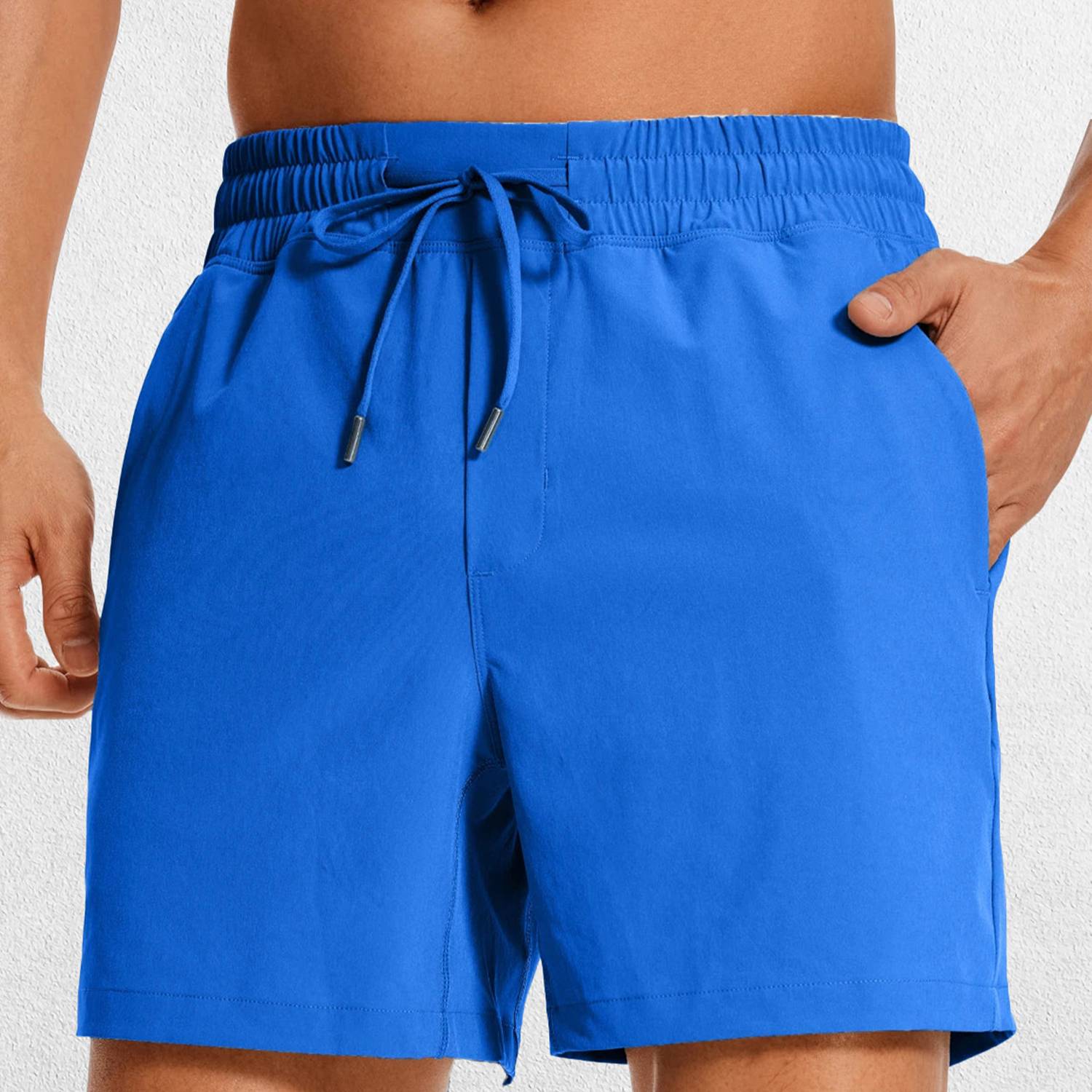 Close-up of Royal Blue GPW Men's Lightweight Quick-Dry Workout Shorts with Pockets in a studio background