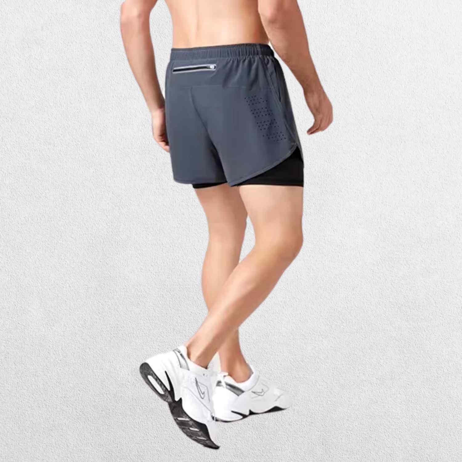"Side angle of the GPW High-Performance Men’s Running Shorts in dark grey, featuring sweat-wicking technology and a modern athletic fit with a neutral studio background."