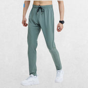 Side angle of the GPW Men's Slim Fit Pencil Pants in grey blue, showing the stretchable fabric and comfort fit with a neutral studio background.