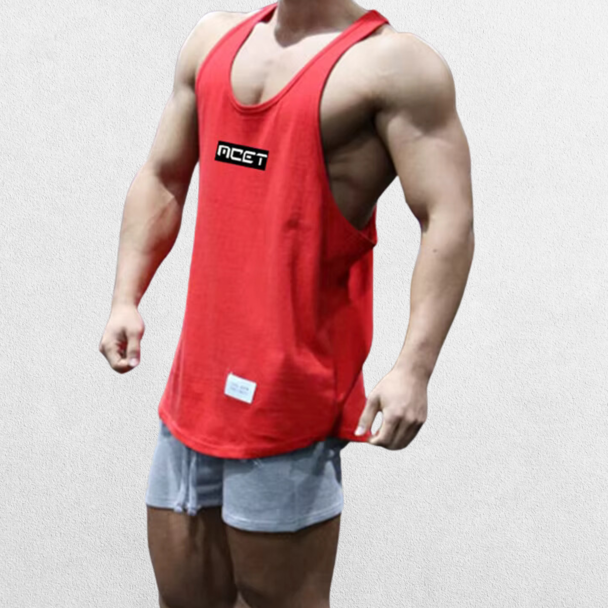 Side profile of the GPW Athletic Gym Tank for Men in red, emphasizing the sleeveless design and workout-friendly cut with a neutral studio background.