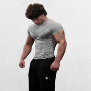 Side profile of the GPW High-Performance Quick-Dry Sports T-Shirt in grey, emphasizing the lightweight, breathable design and movement-friendly cut with a neutral studio background.