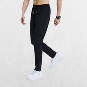 Side profile of the GPW Men's Slim Fit Pencil Pants in black, emphasizing the slim leg design and stretch fabric with a neutral studio background.