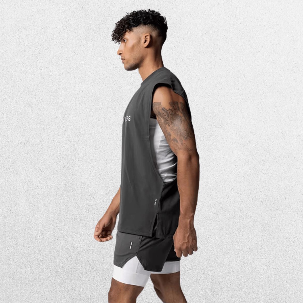 Side view of GPW Men's Performance Round Neck Sleeveless Shirt in grey, featuring the clean lines and comfortable fit with a subtle studio background.