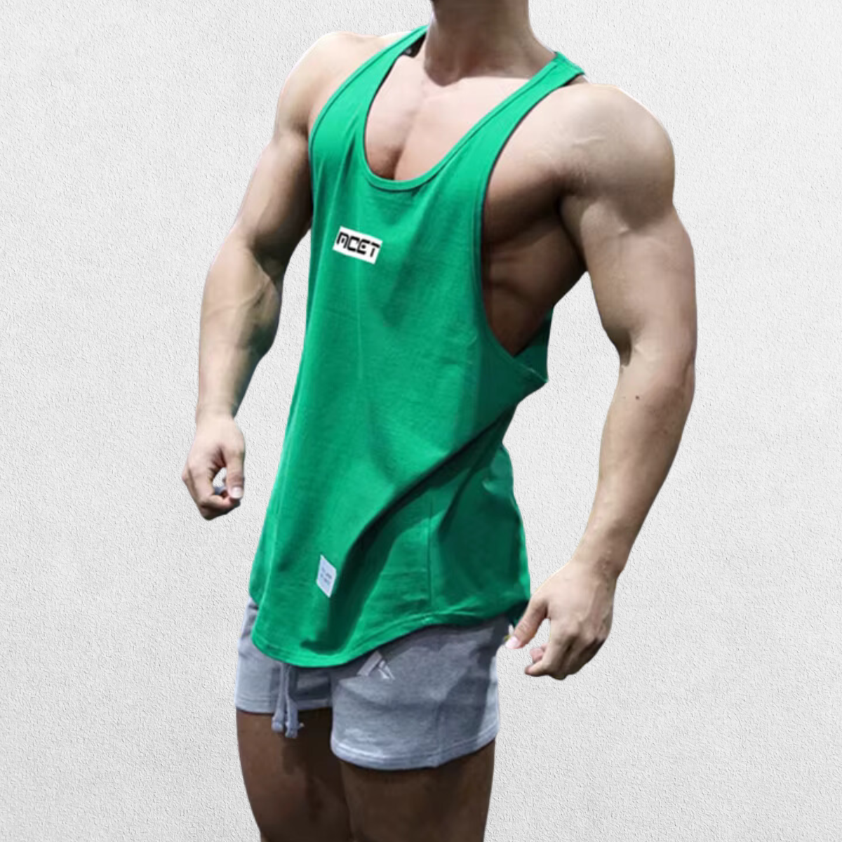 Side view of the GPW Athletic Gym Tank for Men in green, showcasing the muscle-defining cut with a neutral studio backdrop.