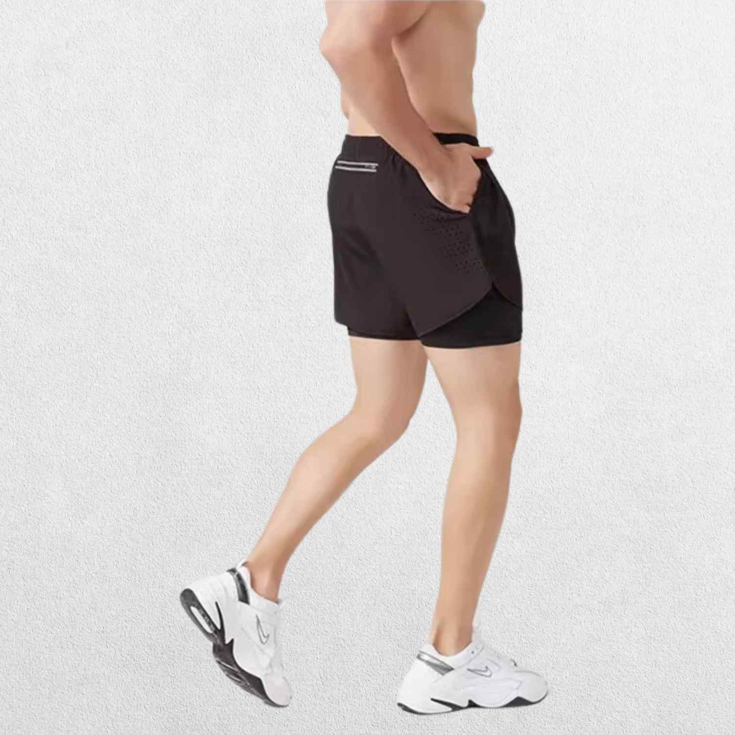 Side view of the GPW High-Performance Men’s Running Shorts in black, showcasing the breathable material and side slits for enhanced mobility with a neutral studio backdrop.