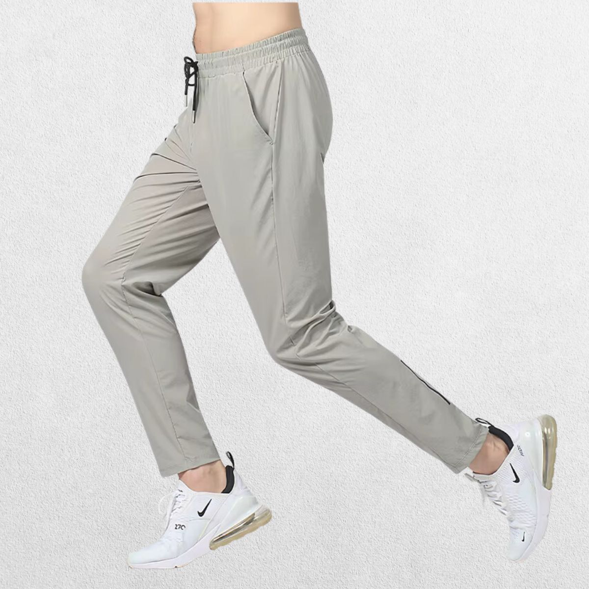 Side view of the GPW Men's Slim Fit Pencil Pants in grey, highlighting the slim fit and ankle cuff design with a neutral studio backdrop.