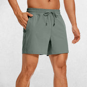 Front Close-up of Slate Gray GPW Men's Lightweight Quick-Dry Workout Shorts with Pockets in a studio background