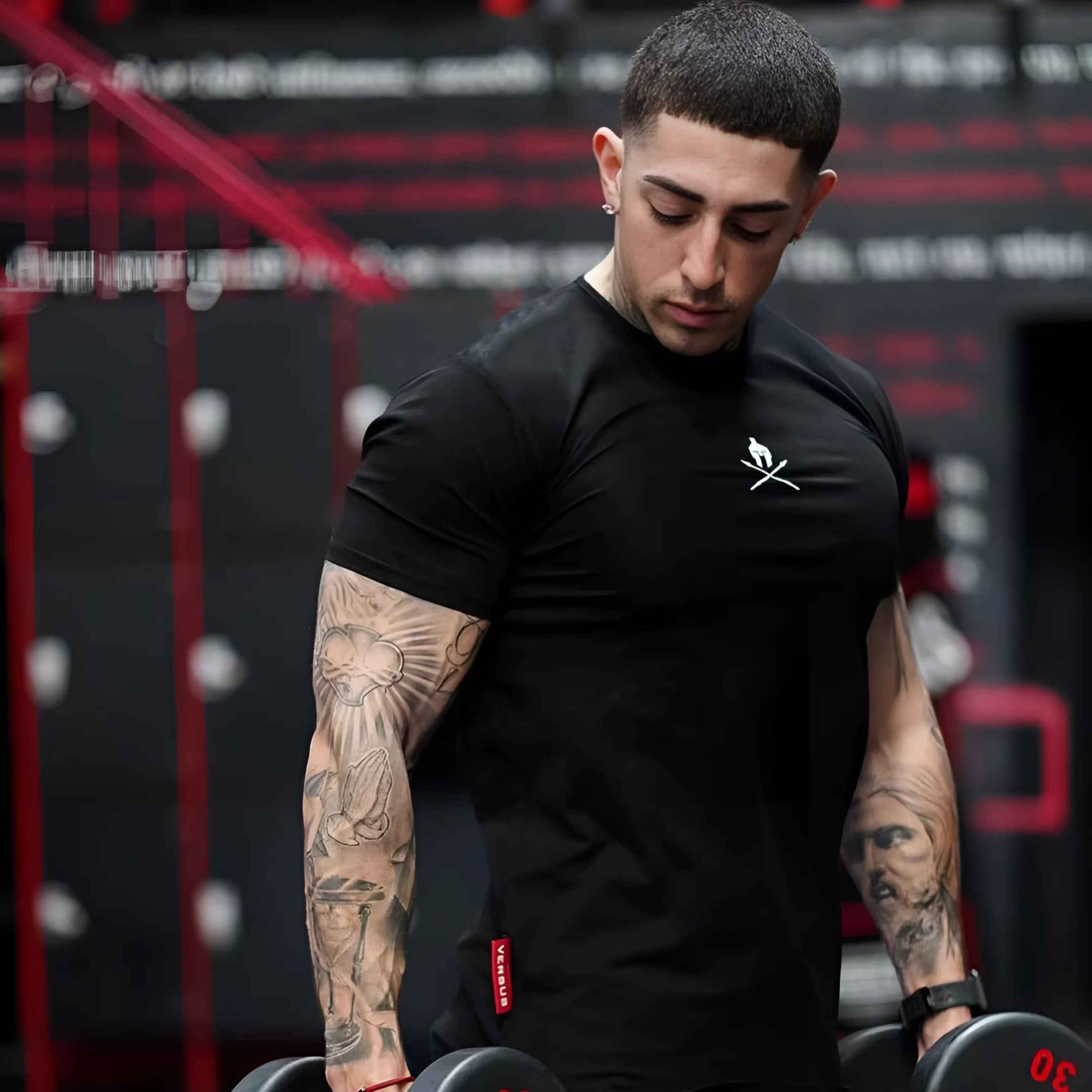 Model wearing black Summer Men’s Cotton Gym T-Shirt while lifting weights in the gym, showcasing comfort and flexibility.