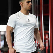 Model wearing white Summer Men’s Cotton Gym T-Shirt during a workout, highlighting its breathable and flexible fit.
