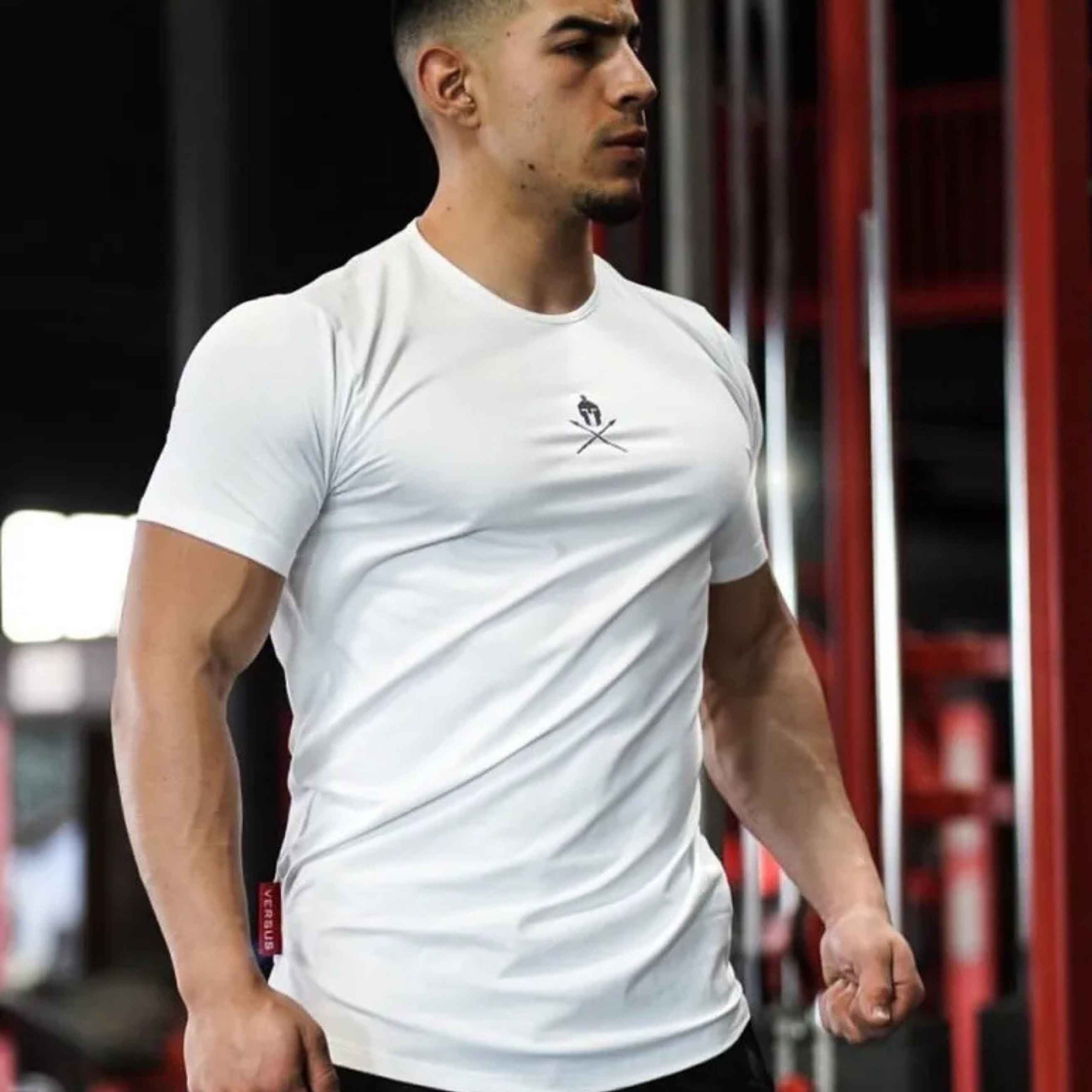 Model wearing white Summer Men’s Cotton Gym T-Shirt during a workout, highlighting its breathable and flexible fit.