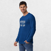 Model wearing the True Royal GPW Never Give Up Performance Long Sleeve Tee with jeans in a studio background.