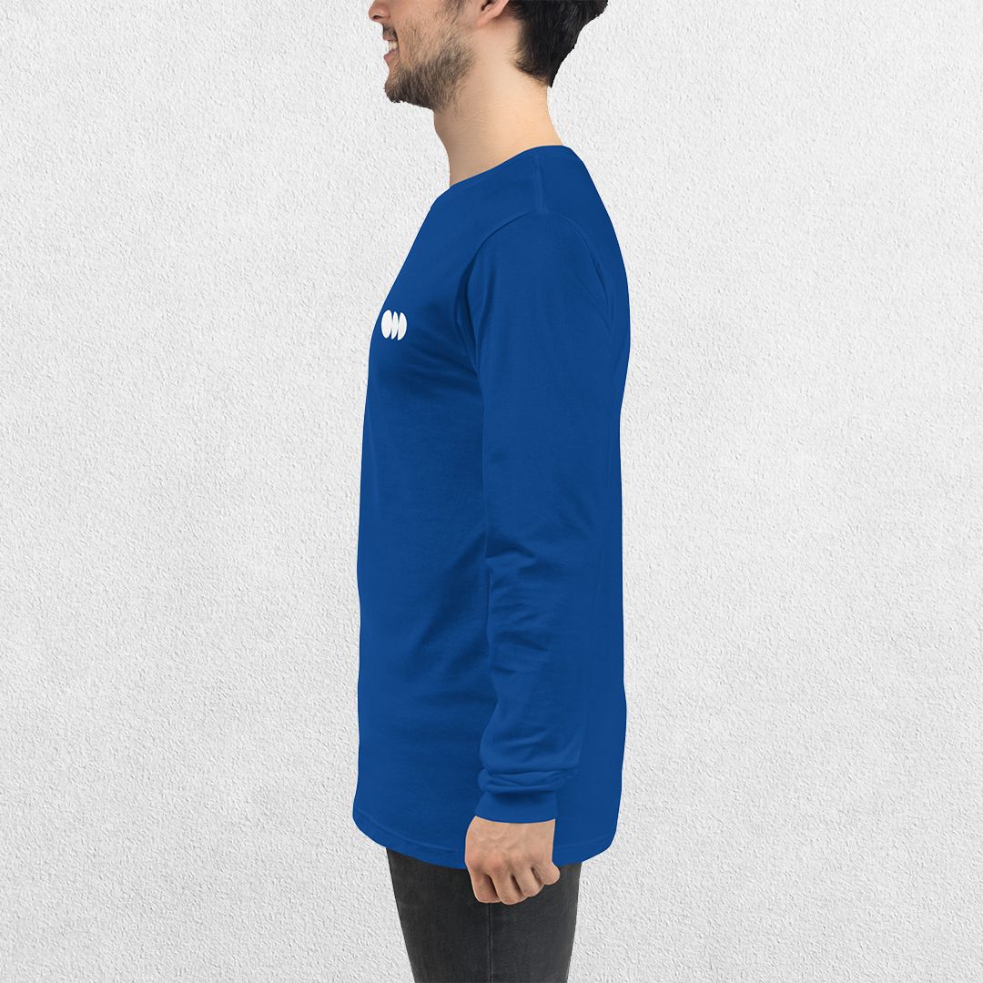 Side View of Model wearing the True ROyal GPW Long Sleeve Tee paired with jeans in a Studio Background.