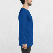 Side View of Model wearing the True ROyal GPW Long Sleeve Tee paired with jeans in a Studio Background.