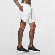 Side Pose of Model Wearing White GPW Men's 2-in-1 Running Shorts for Gym & Fitness Workouts