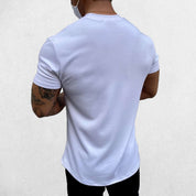 Close-up of White GPW Men's Fit Summer Gym T-Shirt - Bodybuilding Streetwear Tee in a studio background