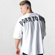 Model wearing White GPW Oversized T-Shirt, styled for streetwear and gym.