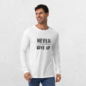 Model wearing the White GPW Never Give Up Performance Long Sleeve Tee with jeans in a studio background.