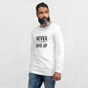 Model wearing the White GPW Never Give Up Performance Long Sleeve Tee with jeans in a studio background.
