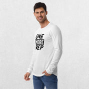 Model wearing the White GPW One More Rep Unisex Motivational Long Sleeve Tee with jeans in studio background.