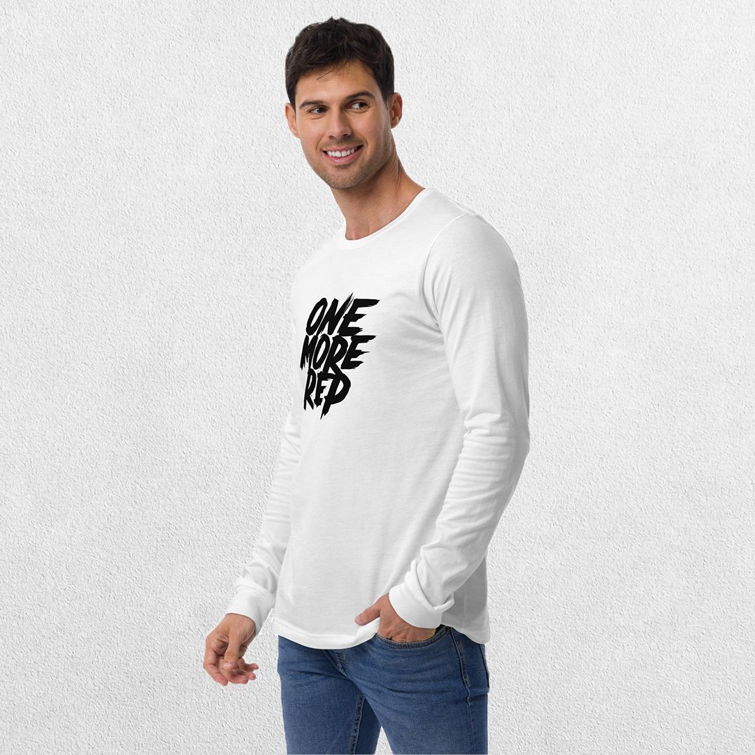 Model wearing the White One More Rep High-Performance Long Sleeve Tee – Unisex Gym Wear with jeans in a studio background.