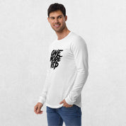 Model wearing the White One More Rep High-Performance Long Sleeve Tee – Unisex Gym Wear with jeans in a studio background.