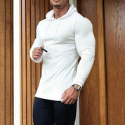 Model styling the white Men’s Slim Fit Sport Hoodie in a casual lifestyle setting