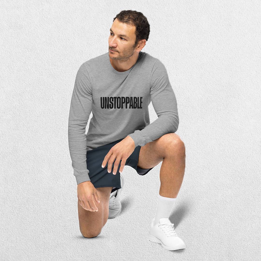 Sitting Model wearing the Athletic heather GPW Unisex Long Sleeve Tee with Unstoppable Design .