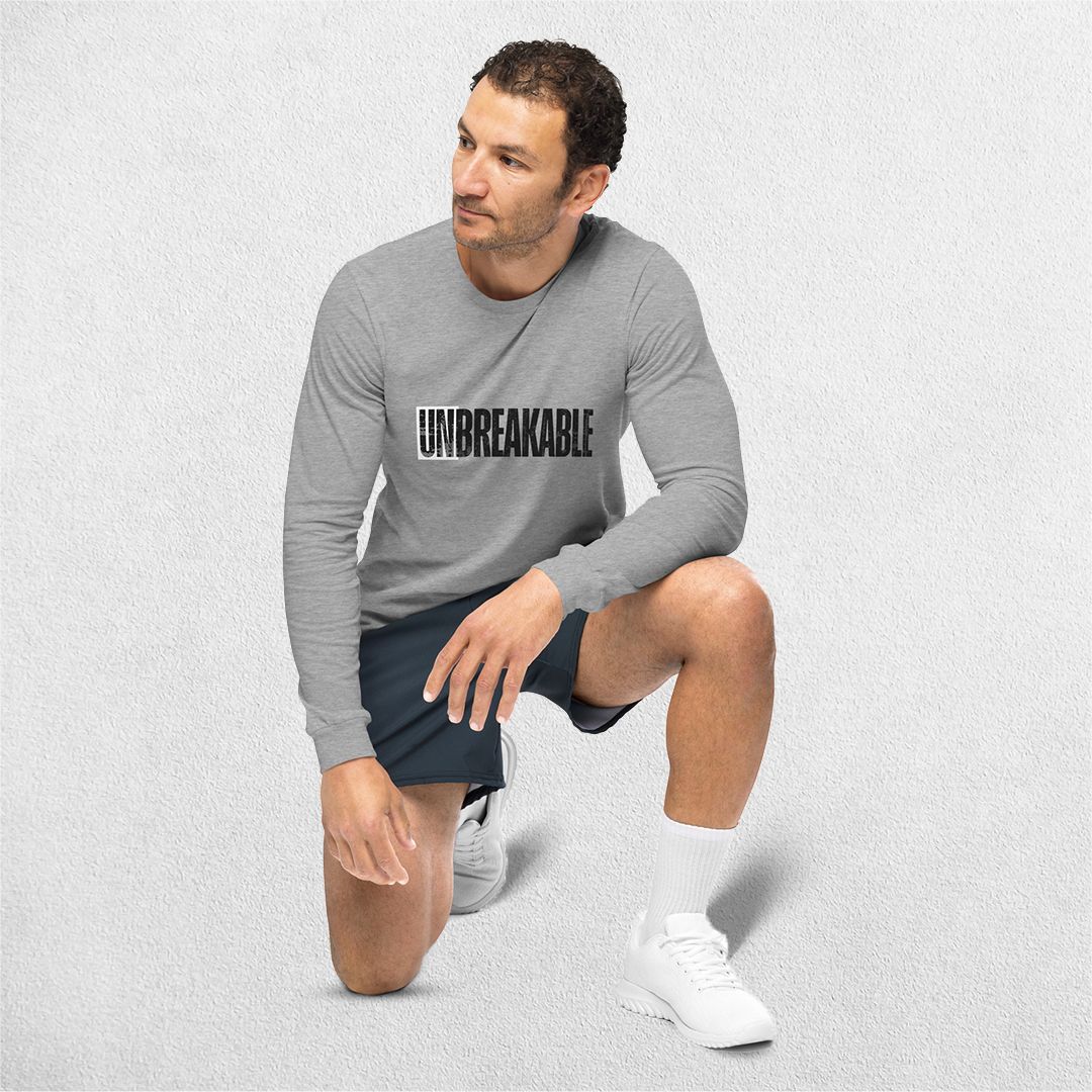 Sitting Model wearing the Athletic Heather Unbreakable Printed Unisex Long Sleeve Tee – Durable and Versatile Style