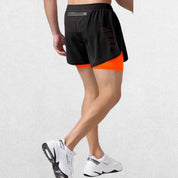 Back view of the GPW High-Performance Men’s Running Shorts in fluorescent orange, showcasing the sporty cut, reflective details, and ergonomic fit against a clean studio setting."
