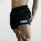 Model wearing Black GPW Men's Quick-Dry Fitness Shorts - Loose Beach Workout Bottoms