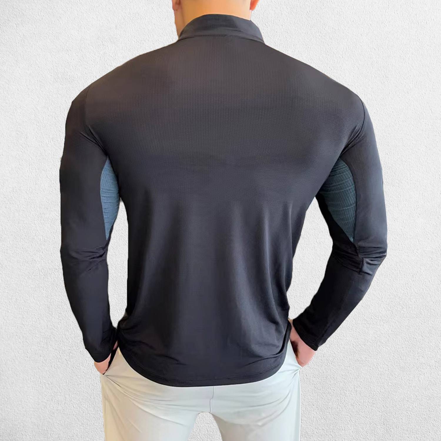 Back Pose of Model wearing Black Men's Activewear Sweat-Wicking High Collar Compression Top with Long Sleeves