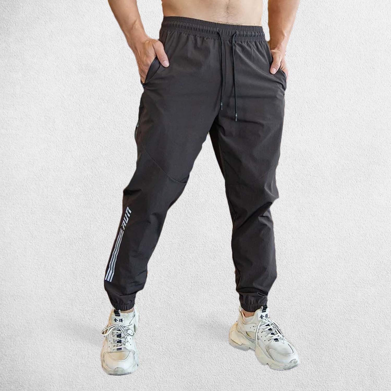 Model Wearing Black Sweet pant Men’s gym sweatpants with elastic waistband and zipper pockets for secure storage 