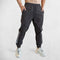 Model Wearing Black Sweet pant Men’s gym sweatpants with elastic waistband and zipper pockets for secure storage 