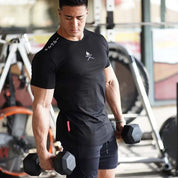 Model wile having work out wearing Black Men’s Letter Print Gym T-Shirt – Muscle Fit, Crew Neck, Cotton Workout Tee