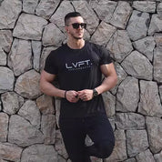 Model wearing Black Men’s Quick-Dry Running T-Shirt – Breathable & Lightweight Sportswear for Fitness & Training