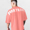 Model wearing Coral Pink GPW Oversized T-Shirt, styled for streetwear and gym.